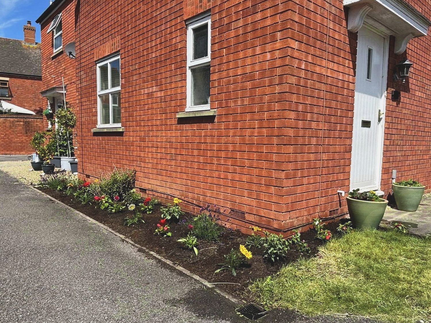 Side border after weeding, planting and a soil refresh