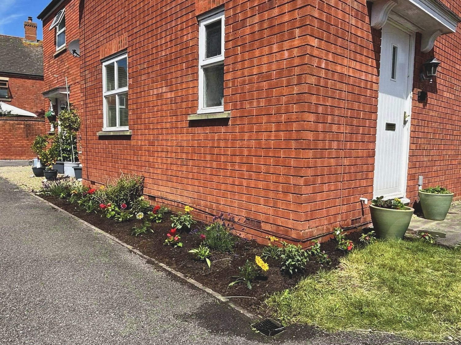 Front border after weeding, edging, soil refresh and fresh planting