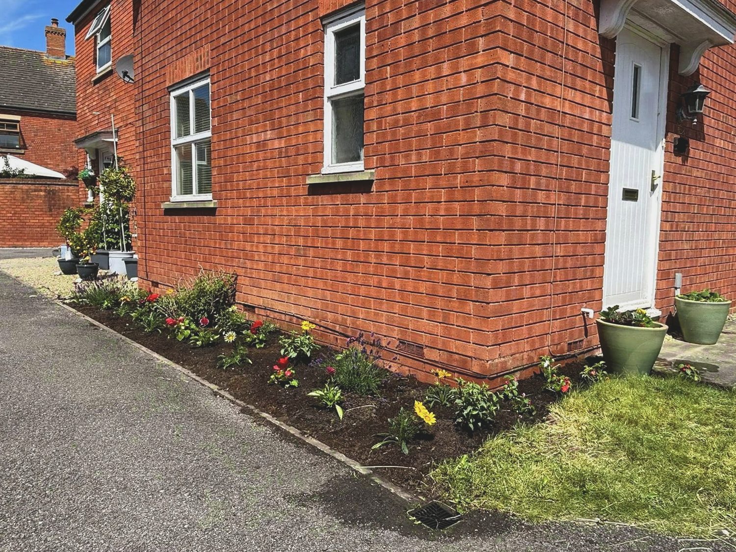 Side border after weeding, planting and a soil refresh