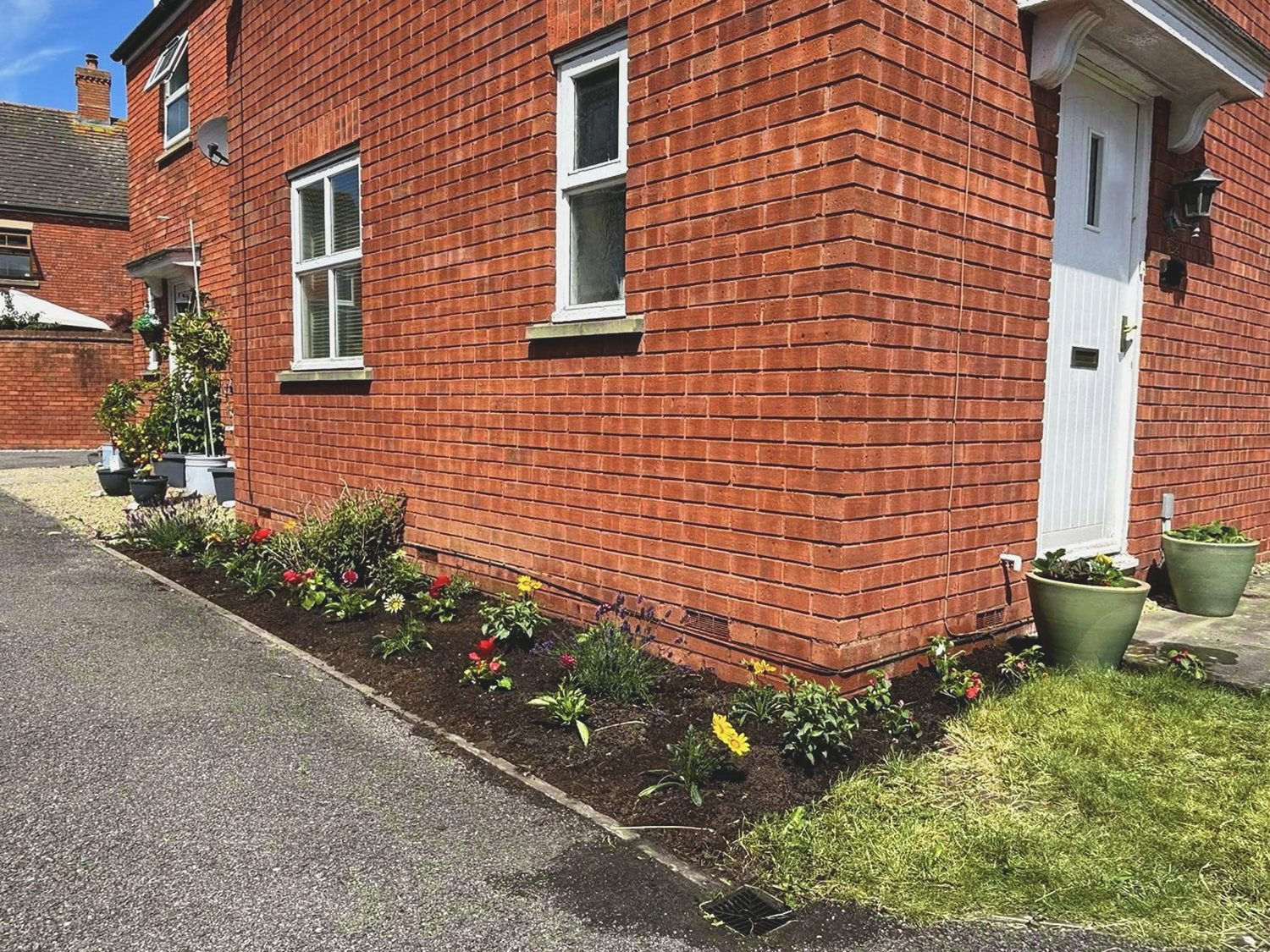 Side border after weeding, planting and a soil refresh