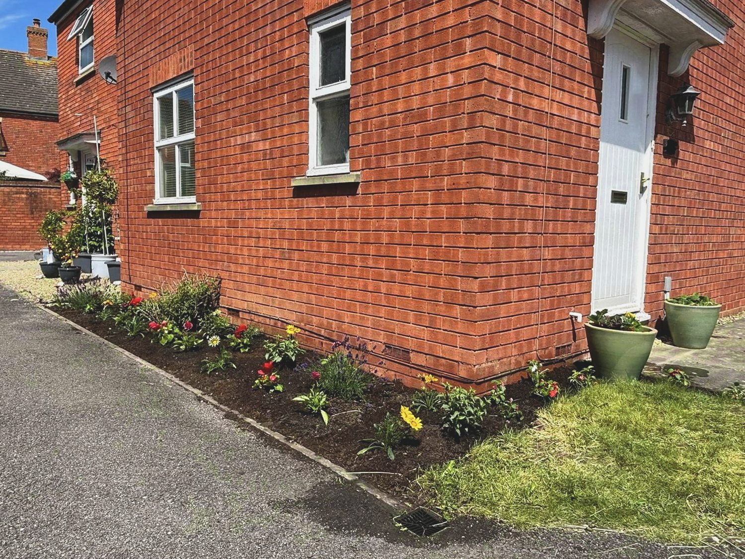 Side border after weeding, planting and a soil refresh
