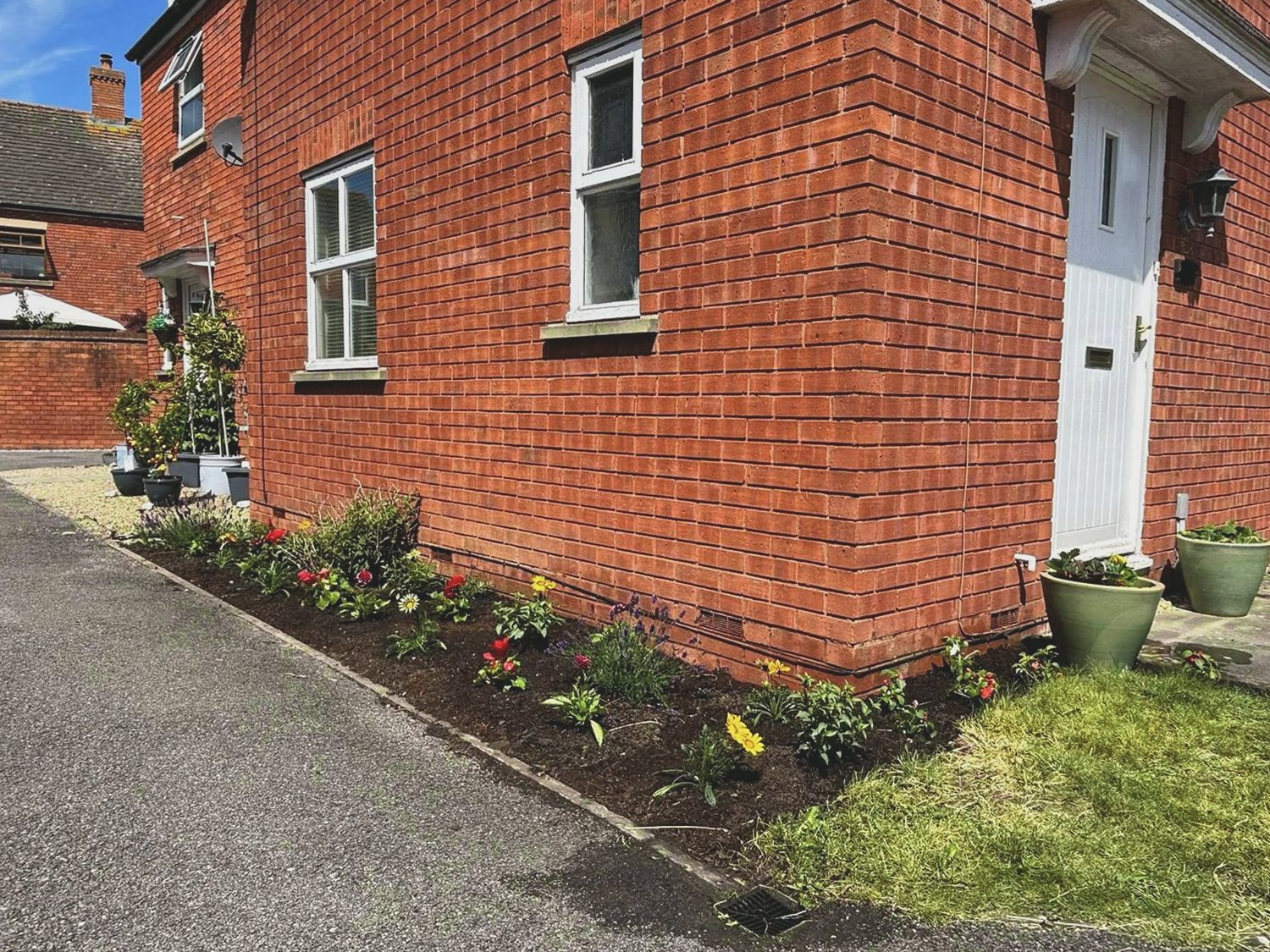 Side border after weeding, planting and a soil refresh