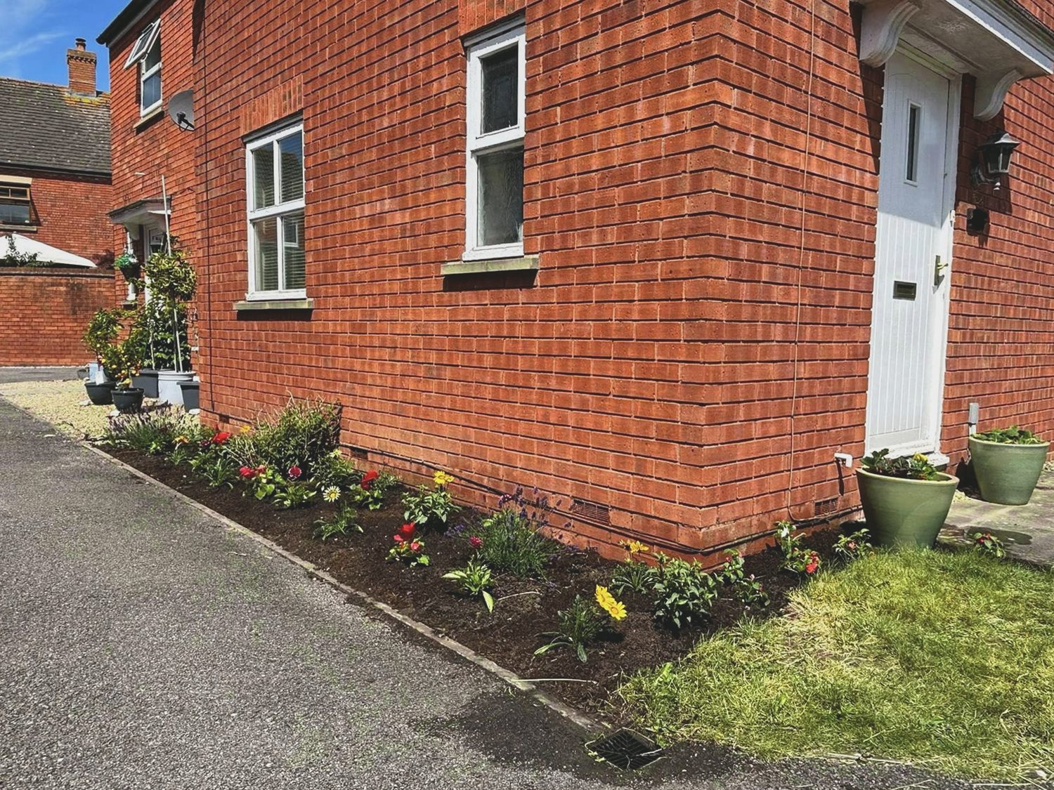 Side border after weeding, planting and a soil refresh